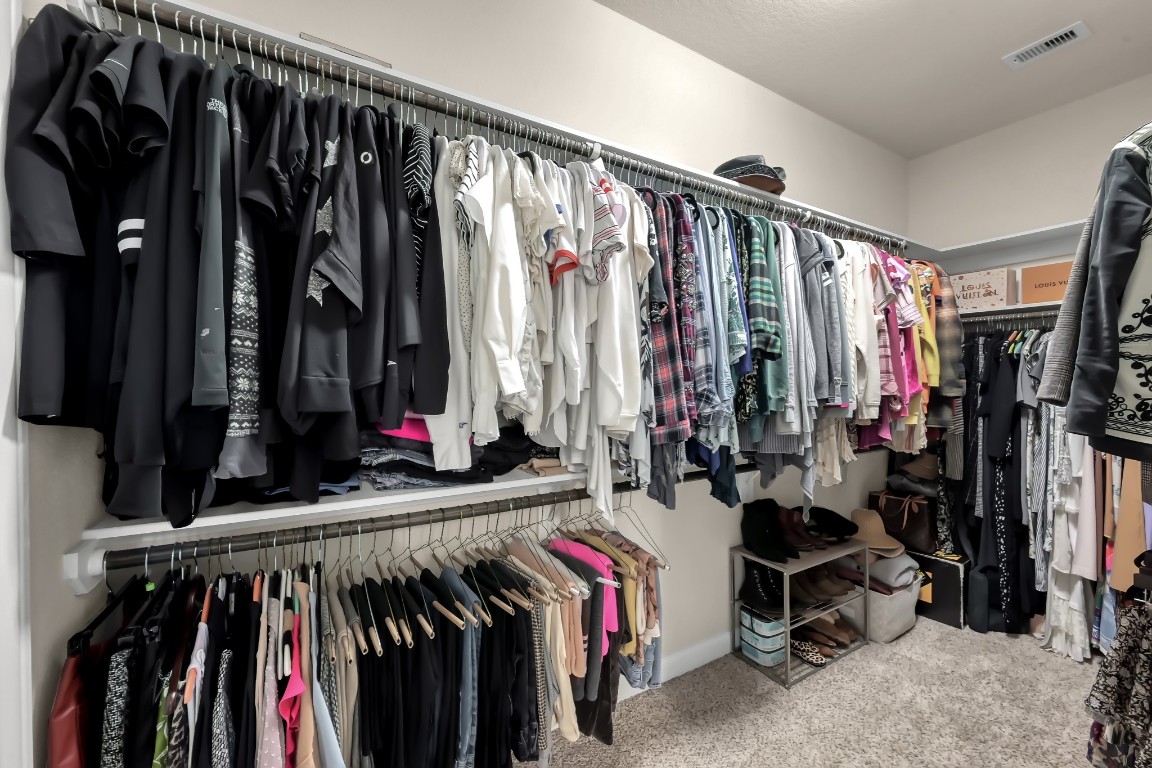 22202 Weller Oaks Drive Spring, TX 77389 - Photo 23 of 39 a view of walk in closet with clothes and shoes