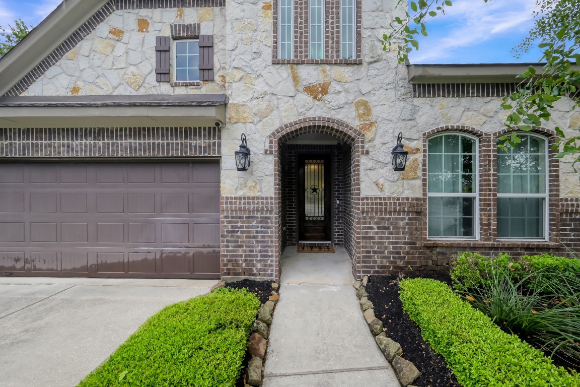 22202 Weller Oaks Drive Spring, TX 77389 - Photo 3 of 39 a front view of a house with a garden