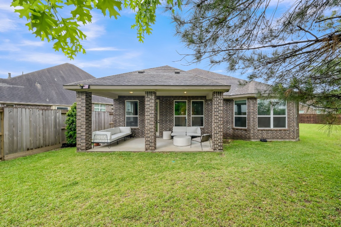 22202 Weller Oaks Drive Spring, TX 77389 - Photo 36 of 39 a front view of a house with backyard garden and patio