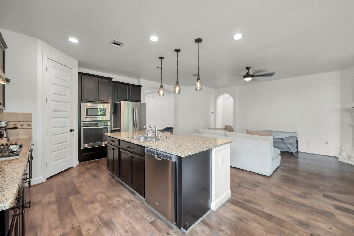 22202 Weller Oaks Drive Spring, TX 77389 - Photo 10 of 39 a kitchen with a stove and a refrigerator