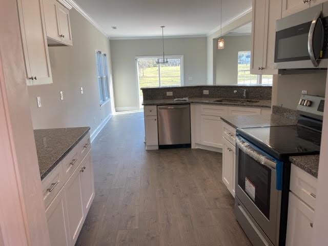 1510 Jack Davis Road Monroe, NC 28112 - Photo 8 of 22 a kitchen with stainless steel appliances granite countertop a stove a sink and a microwave