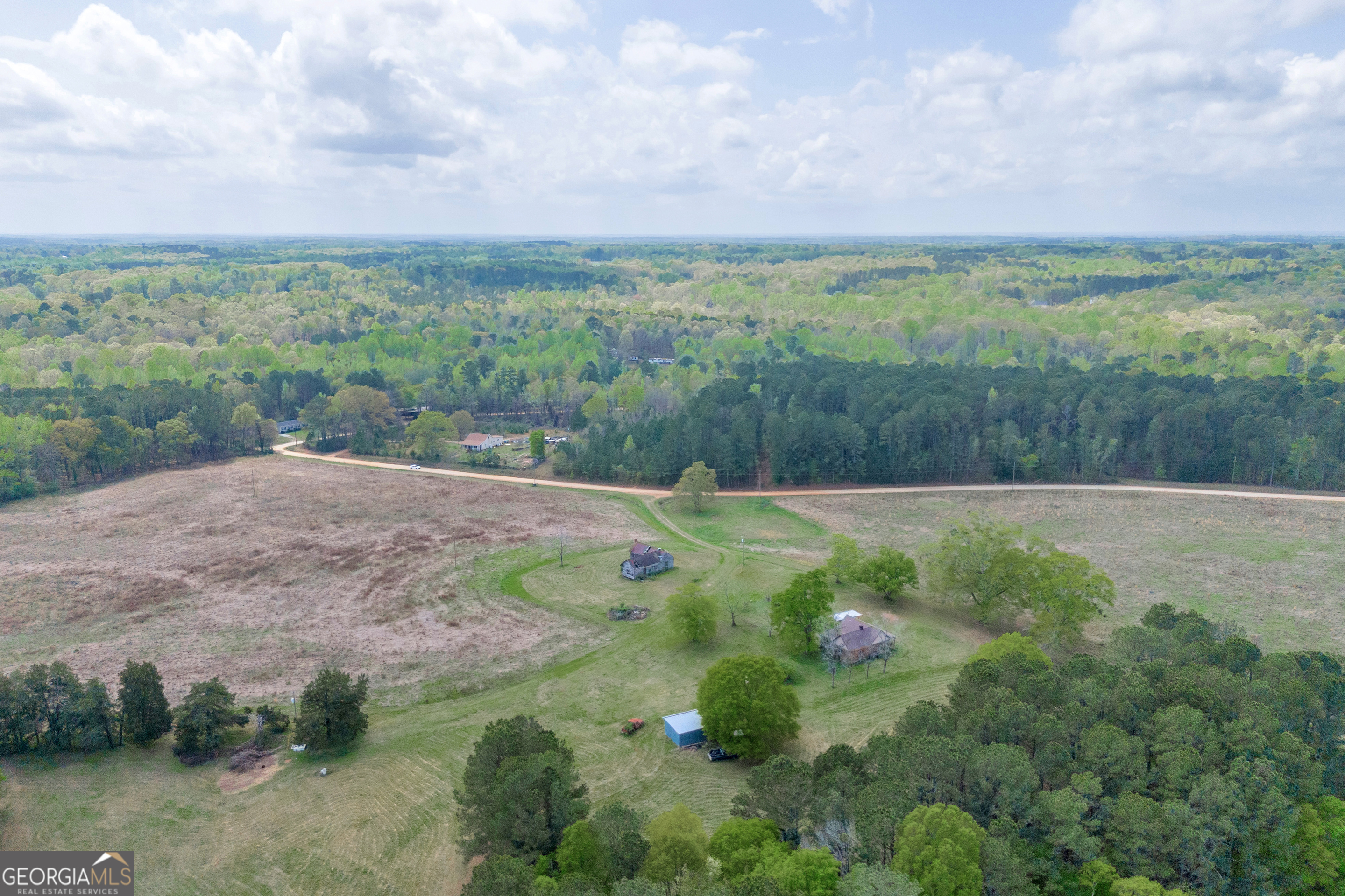 104 Howington Road Winterville, GA 30683 - Photo 22 of 74 a view of a lush green outdoor space with swimming pool and valleys in the background