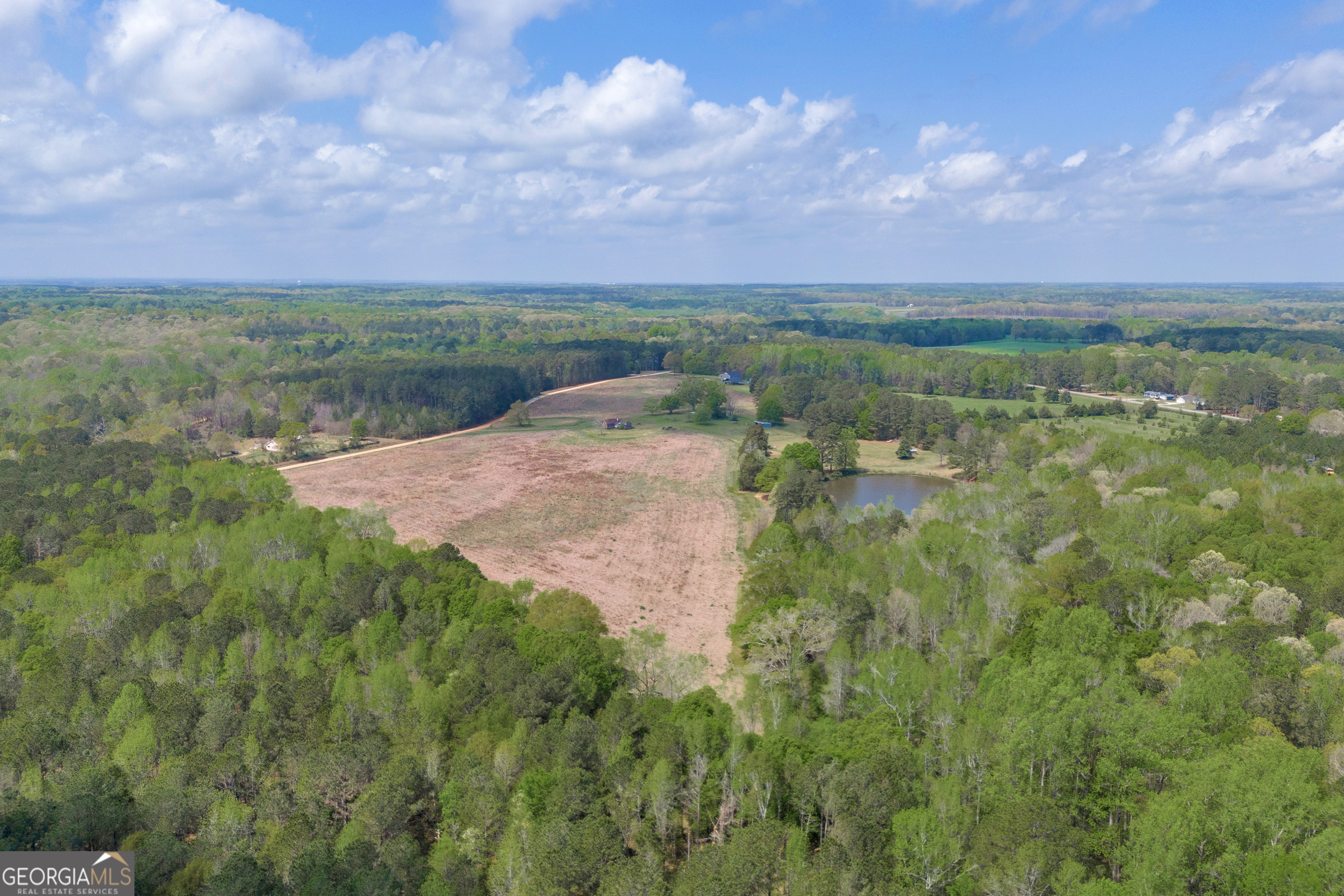104 Howington Road Winterville, GA 30683 - Photo 33 of 74 a view of a big yard with lots of green space and mountain view in back