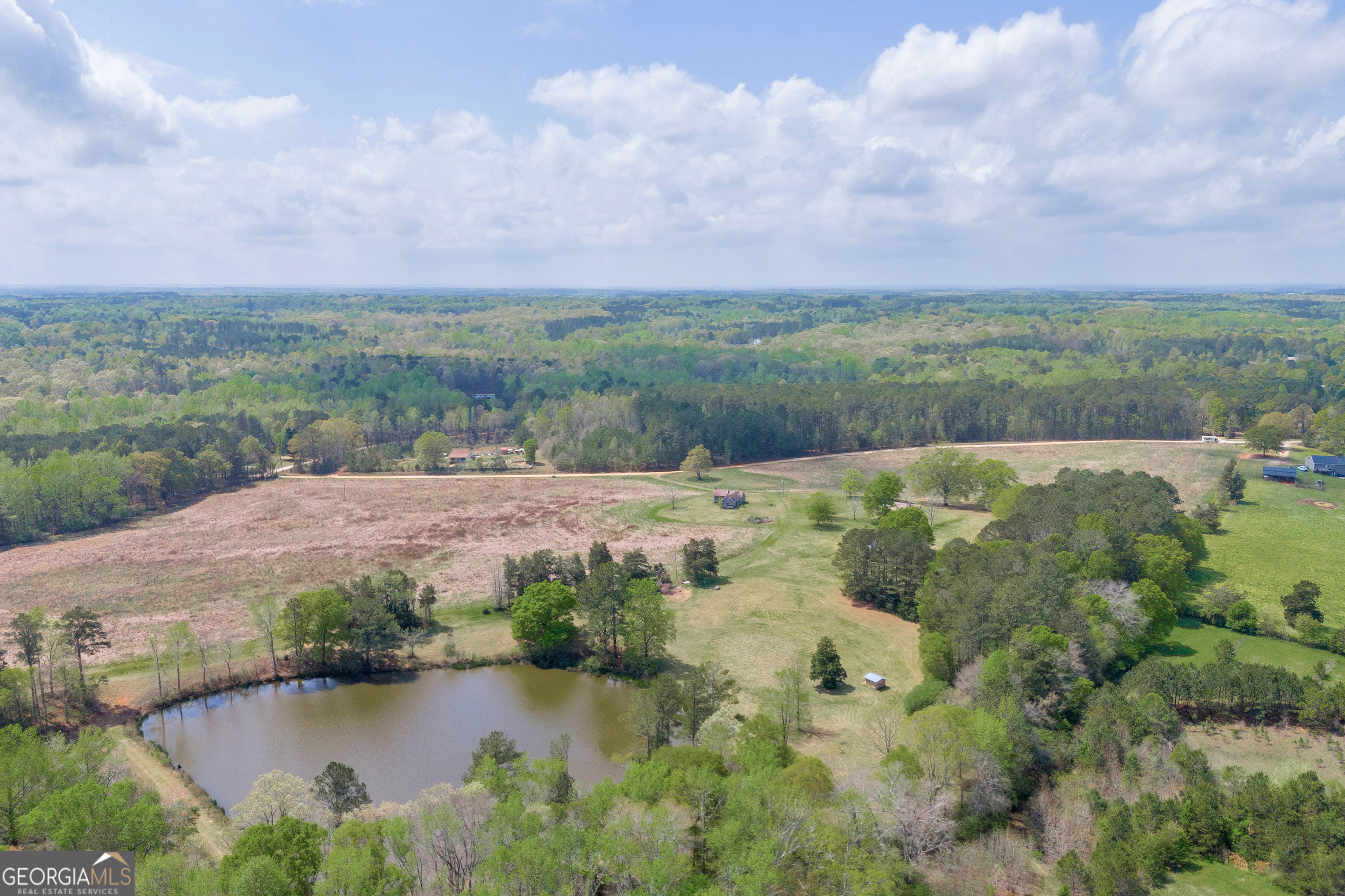 104 Howington Road Winterville, GA 30683 - Photo 7 of 74 a view of a lake with houses in the back