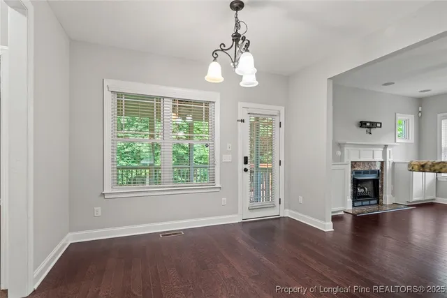 a view of a livingroom with furniture window wooden floor and front door