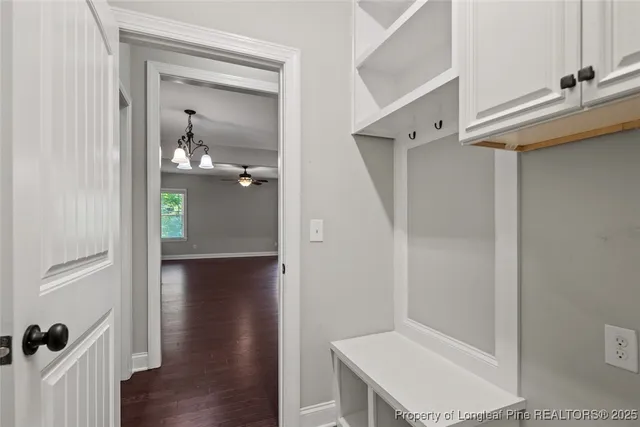 a view of hallway with wooden floor
