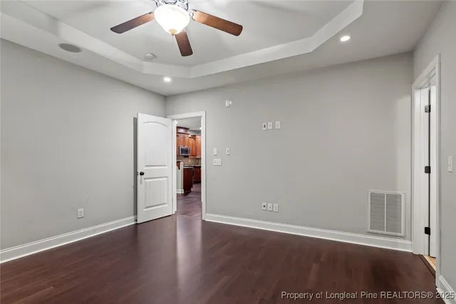 a view of an empty room with wooden floor