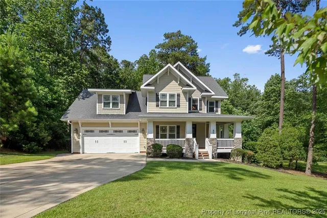 a front view of a house with a garden and swimming pool