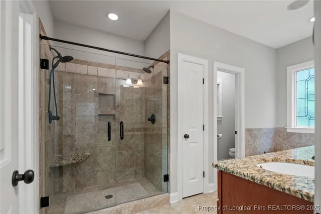 a bathroom with a granite countertop shower mirror and a sink