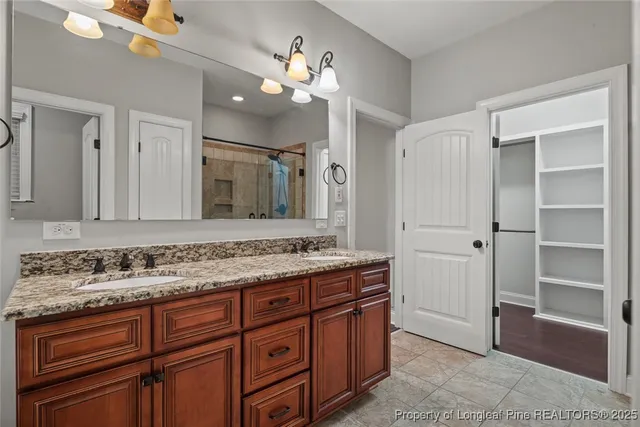 a bathroom with a sink vanity granite and a mirror