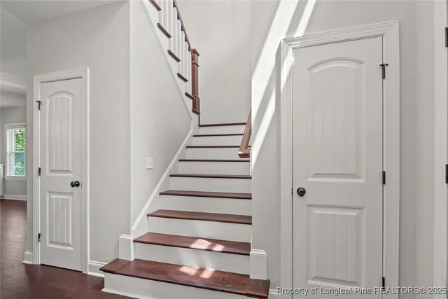 a view of front door with wooden floor and stairs