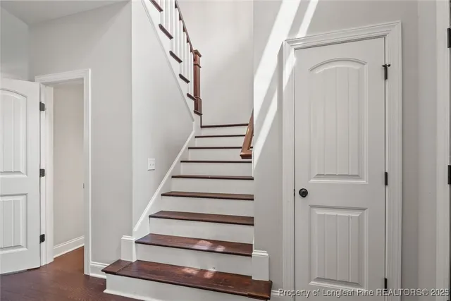 a view of entryway with wooden floor and stairs