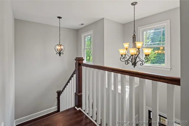 a view of an entryway with wooden floor and windows