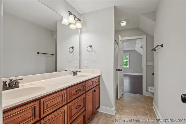 a spacious bathroom with a sink and a mirror