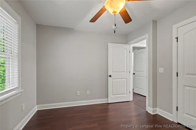 a view of an empty room and window with wooden floor