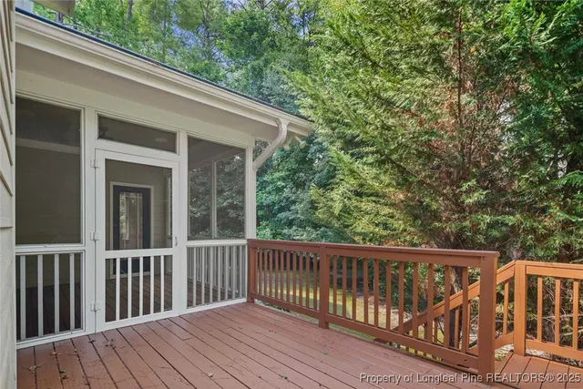 a balcony with wooden floor and fence