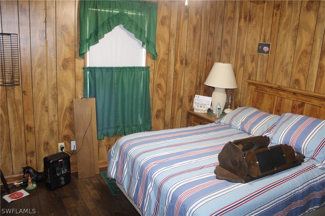 5470 Rainbow Drive Bokeelia, FL 33922 - Photo 14 of 21 a bedroom with a bed and a lamp