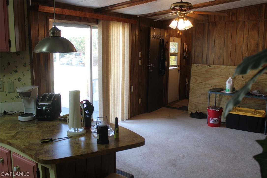 5470 Rainbow Drive Bokeelia, FL 33922 - Photo 21 of 21 a kitchen with sink refrigerator and cabinets