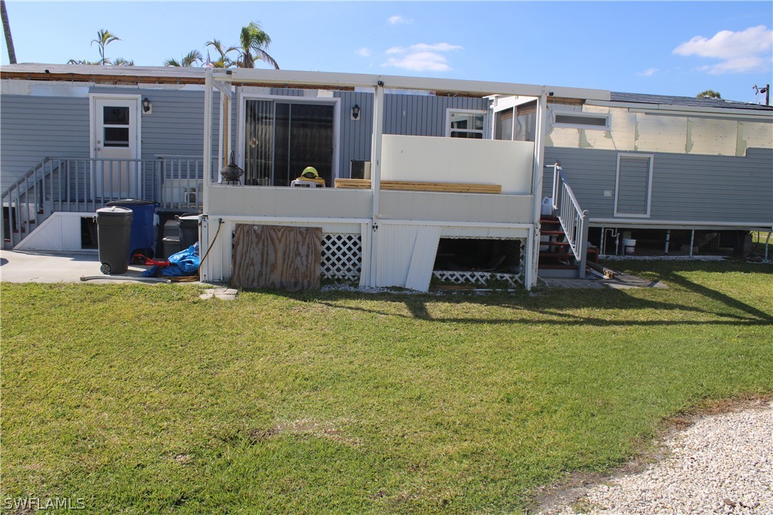 5470 Rainbow Drive Bokeelia, FL 33922 - Photo 4 of 21 a view of a house with swimming pool and a yard