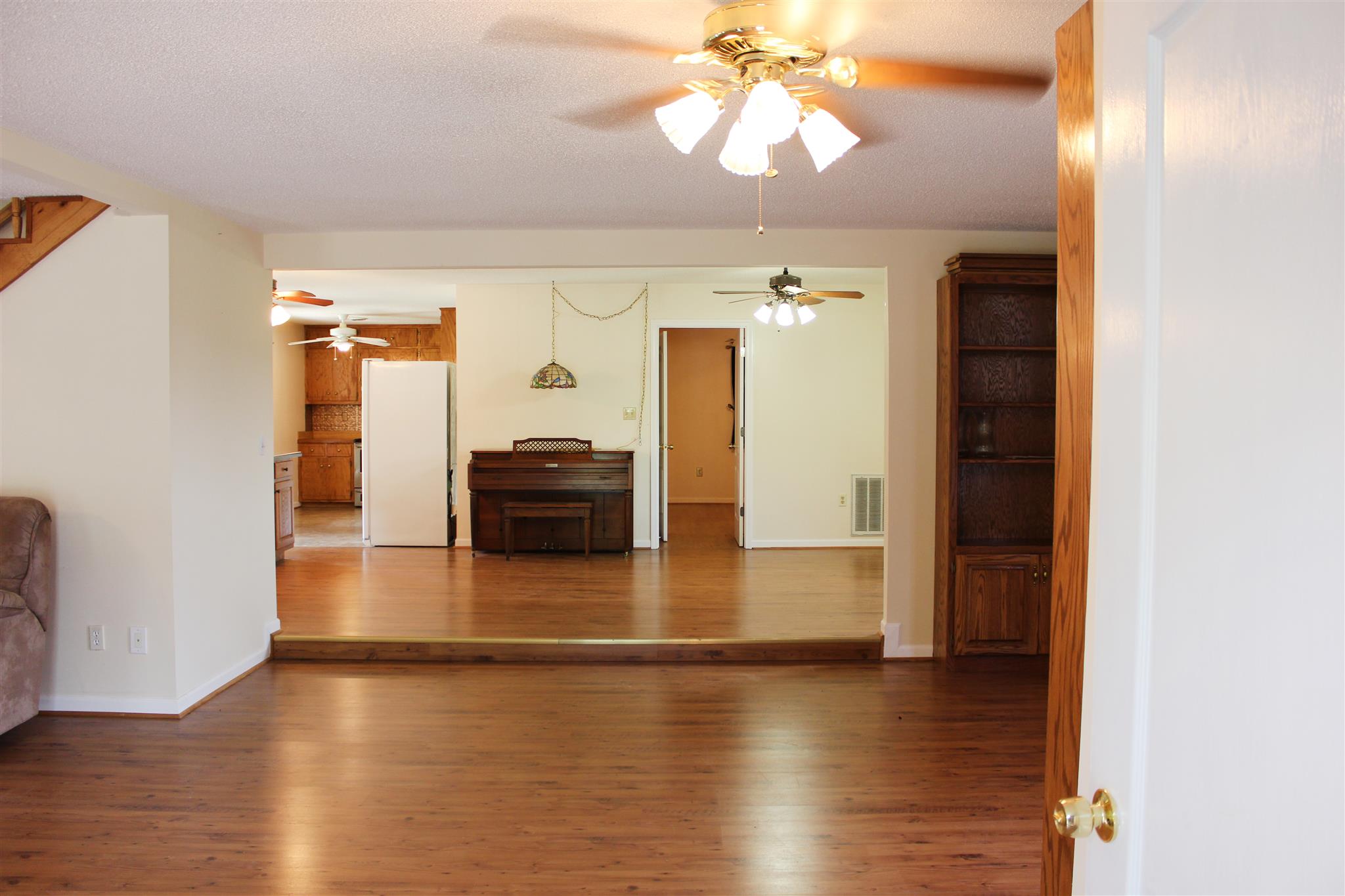 429 Williams Road Morrison, TN 37357 - Photo 9 of 30 a view of a livingroom with wooden floor and a ceiling fan