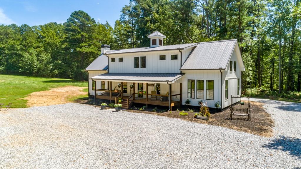 3595 Aaron Sosebee Road Cumming, GA 30028 - Photo 1 of 1 an outdoor space with furniture and garden