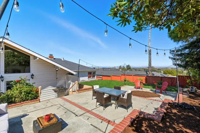 a view of a patio with a table and chairs