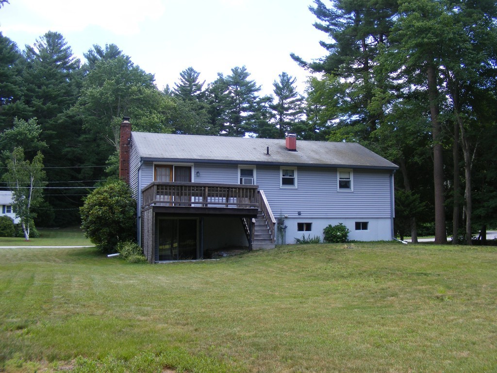 4 Edgar Road Billerica, MA 01821 - Photo 3 of 6 a front view of a house with a garden and trees