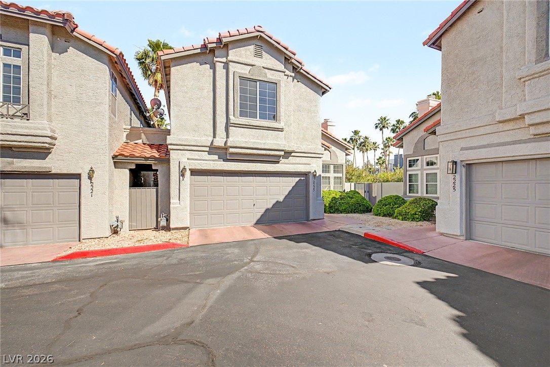 2223 Ramsgate Drive Henderson, NV 89074 - Photo 3 of 32 A Mediterranean-inspired facade with terracotta roof tiles and desert landscaping for effortless curb appeal.