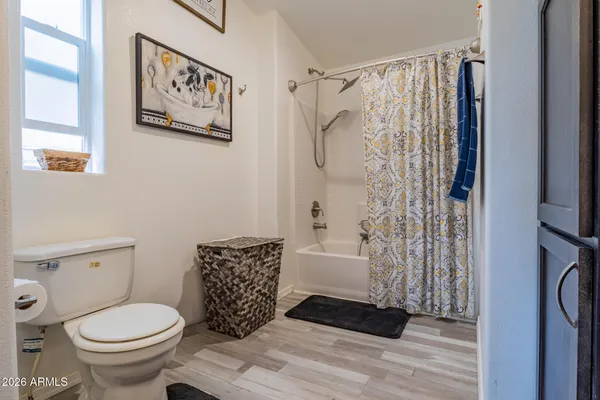 a bathroom with a toilet and a shower curtain