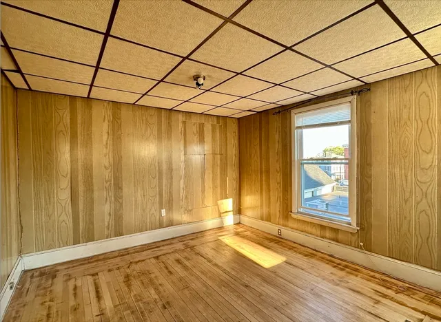 a view of a room with a window and wooden floor