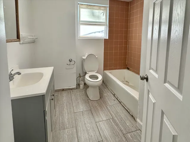 a bathroom with a toilet a sink and bathtub