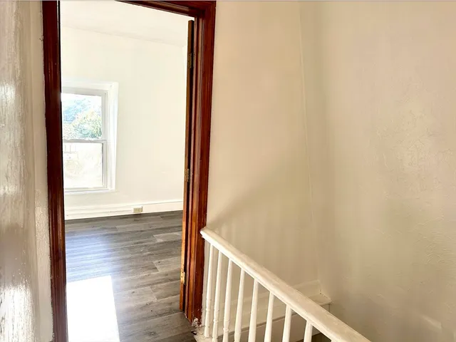 a view of a room with wooden floor and windows
