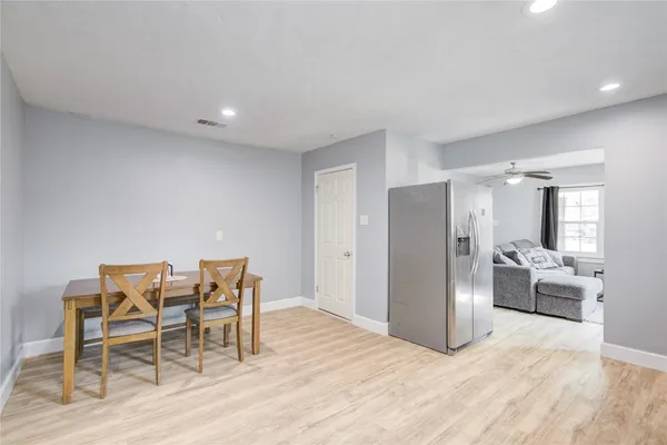 a view of a livingroom with furniture and kitchen view