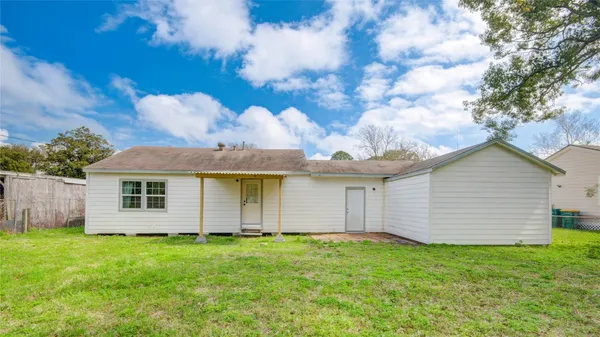 a view of backyard of house with green space