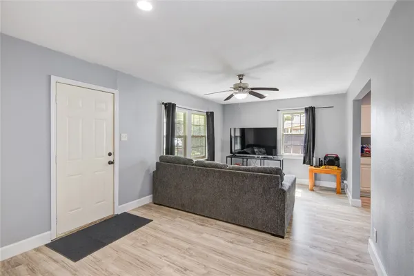 a living room with furniture and a flat screen tv