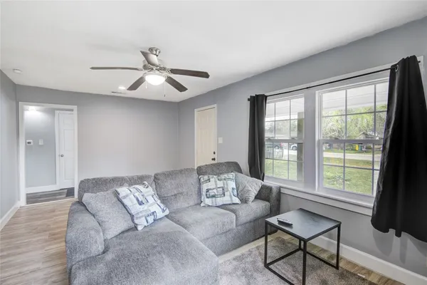 a living room with furniture and a large window