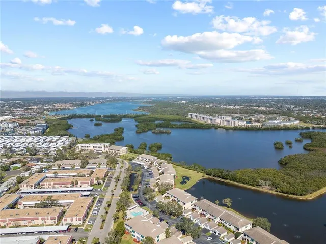a living room with furniture wooden floor and a ceiling fan