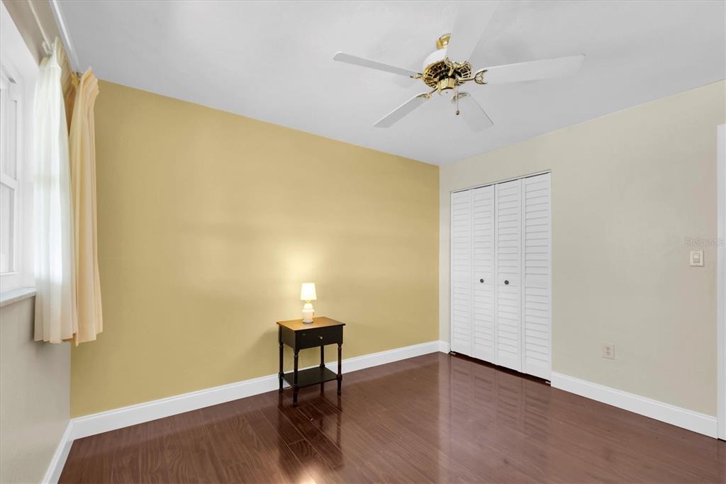 10032 65th Avenue North, Unit 24 St. Petersburg, FL 33708 - Photo 14 of 56 a view of a room with wooden floor and a ceiling fan