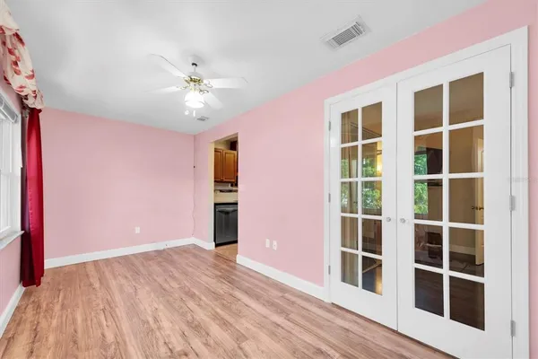 a living room with a table and paintings on the wall