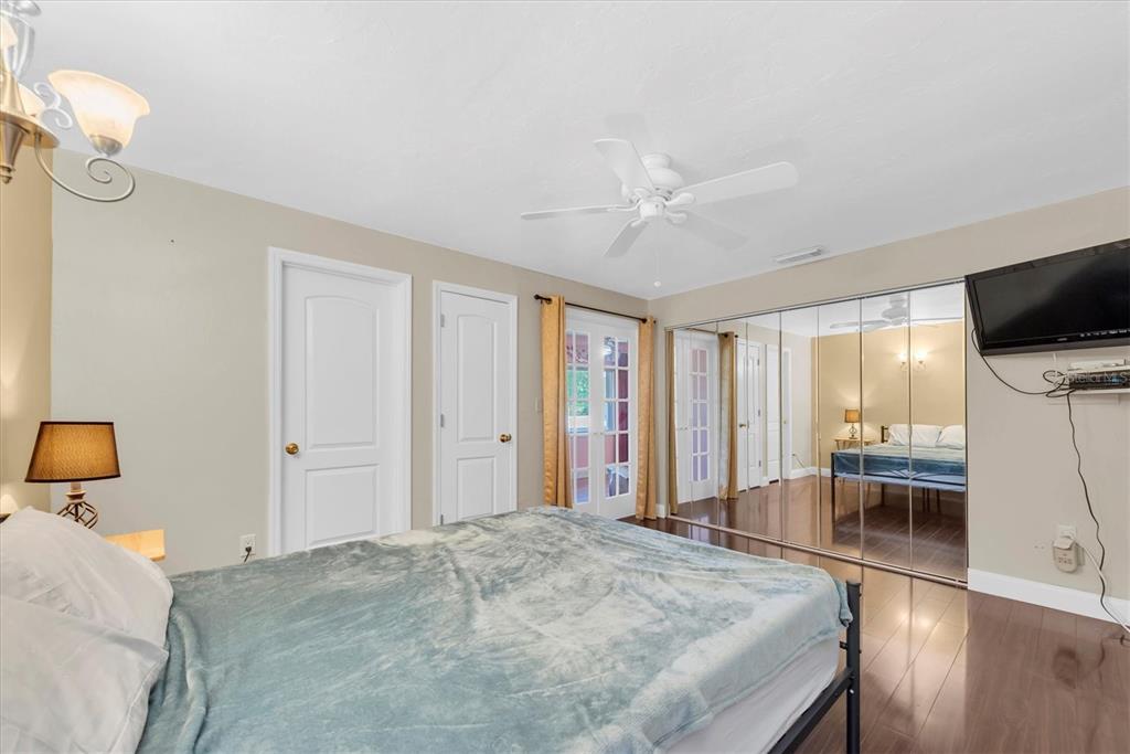 10032 65th Avenue North, Unit 24 St. Petersburg, FL 33708 - Photo 19 of 56 a bedroom with a bed and a flat tv screen on top of it