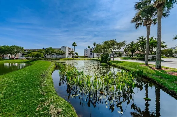 an aerial view of a house with a yard and lake view