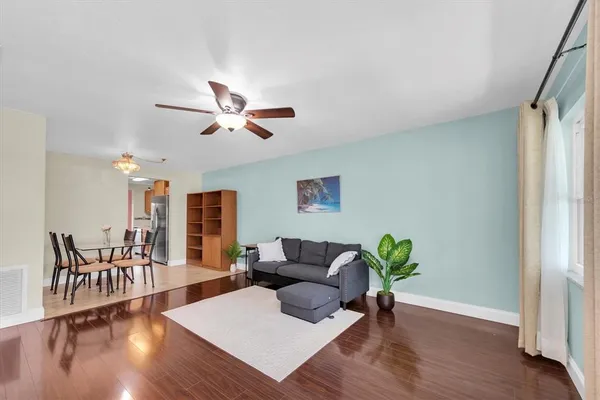 a living room with furniture and wooden floor