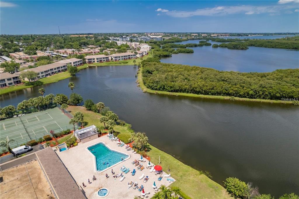 10032 65th Avenue North, Unit 24 St. Petersburg, FL 33708 - Photo 54 of 56 an aerial view of residential houses with outdoor space and lake view