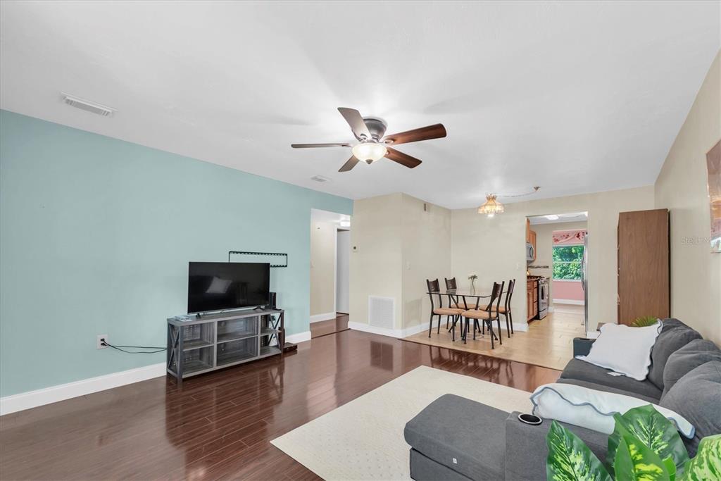 10032 65th Avenue North, Unit 24 St. Petersburg, FL 33708 - Photo 6 of 56 a living room with furniture and a flat screen tv