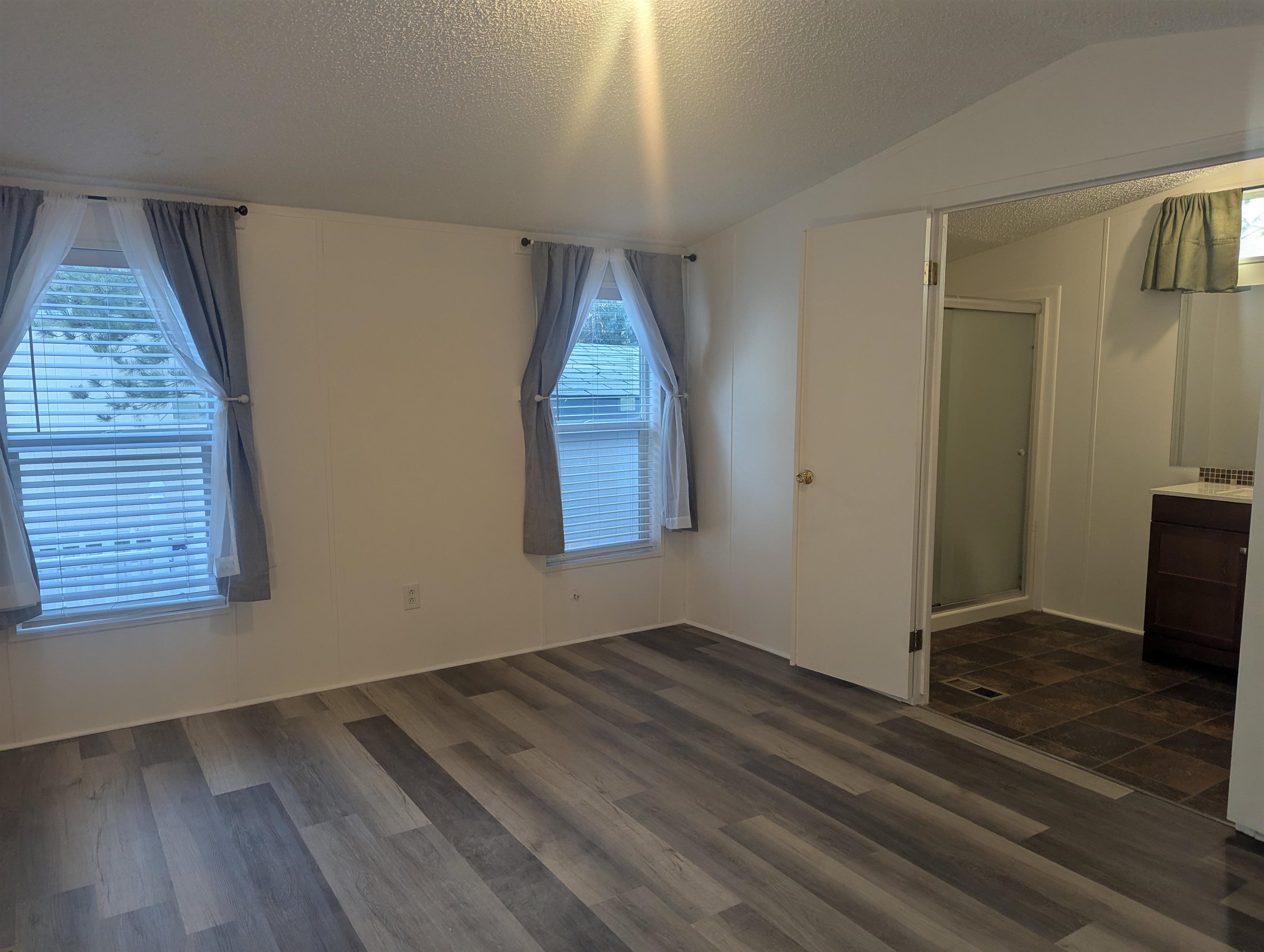 435 32 Road, Unit 254 Clifton, CO 81520 - Photo 13 of 21 an empty room with wooden floor and windows