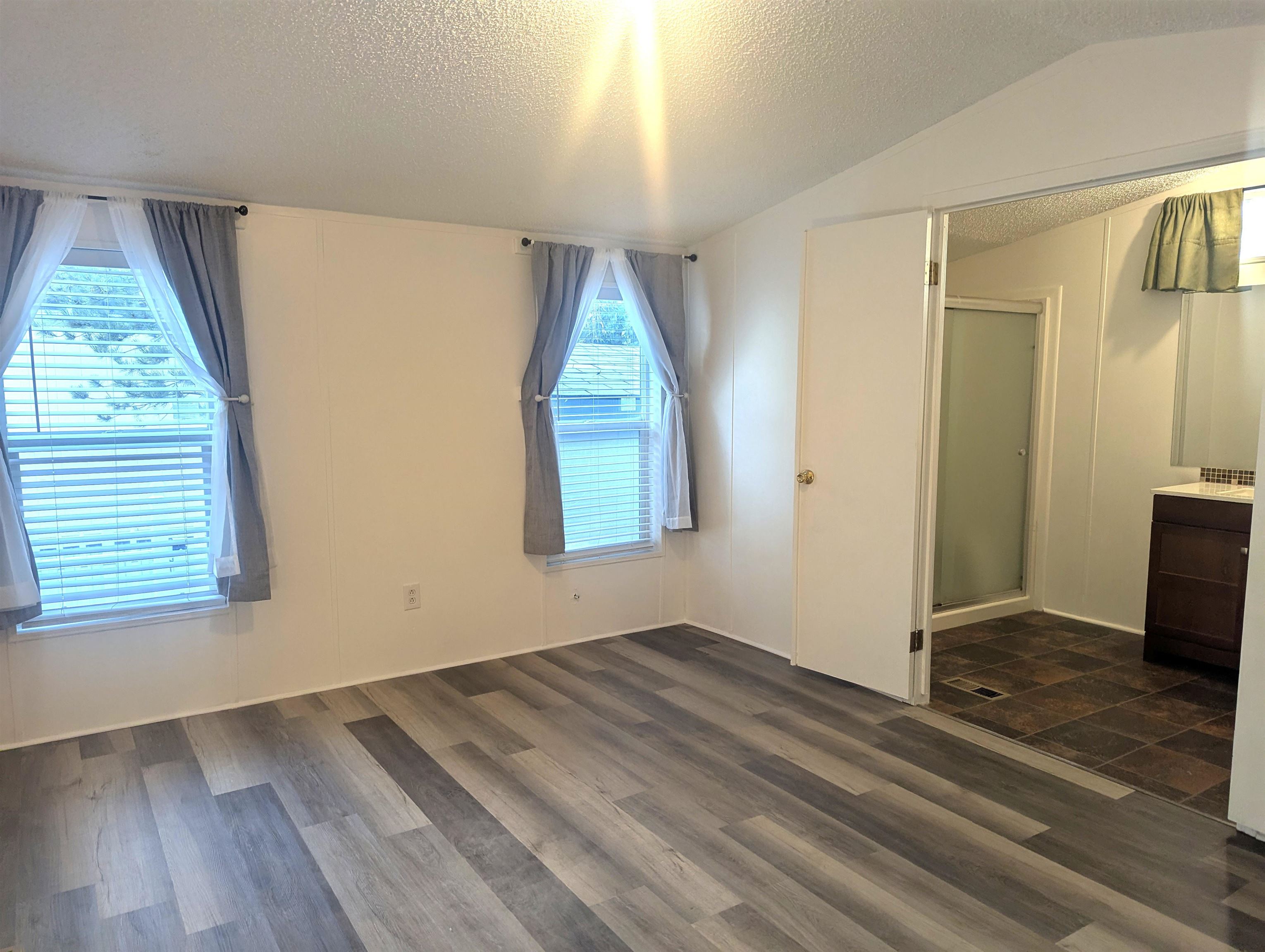 435 32 Road, Unit 254 Clifton, CO 81520 - Photo 15 of 21 an empty room with wooden floor and windows