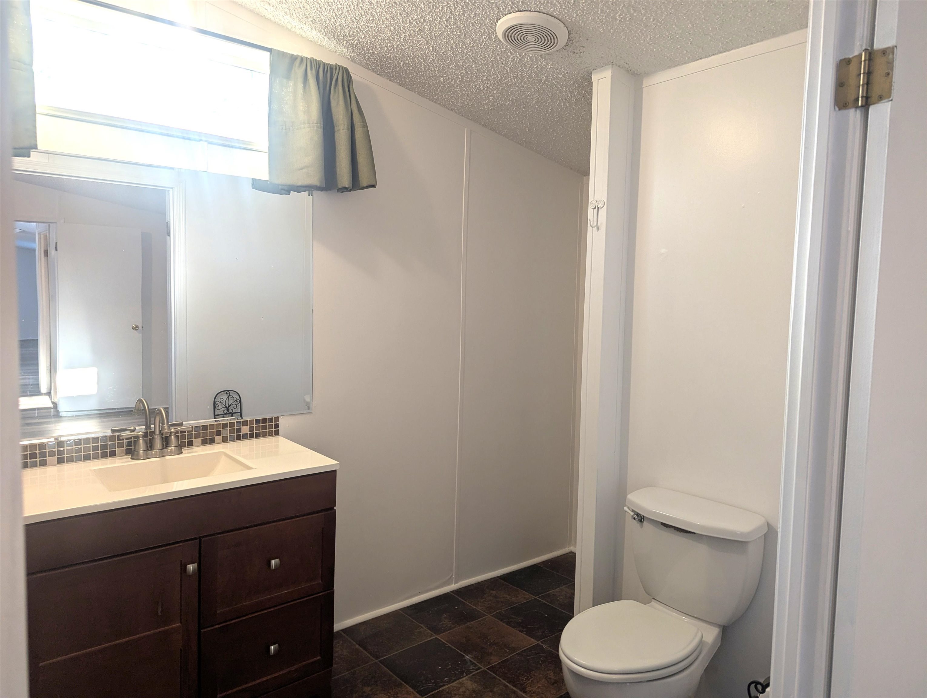 435 32 Road, Unit 254 Clifton, CO 81520 - Photo 18 of 21 a bathroom with a sink a toilet and vanity