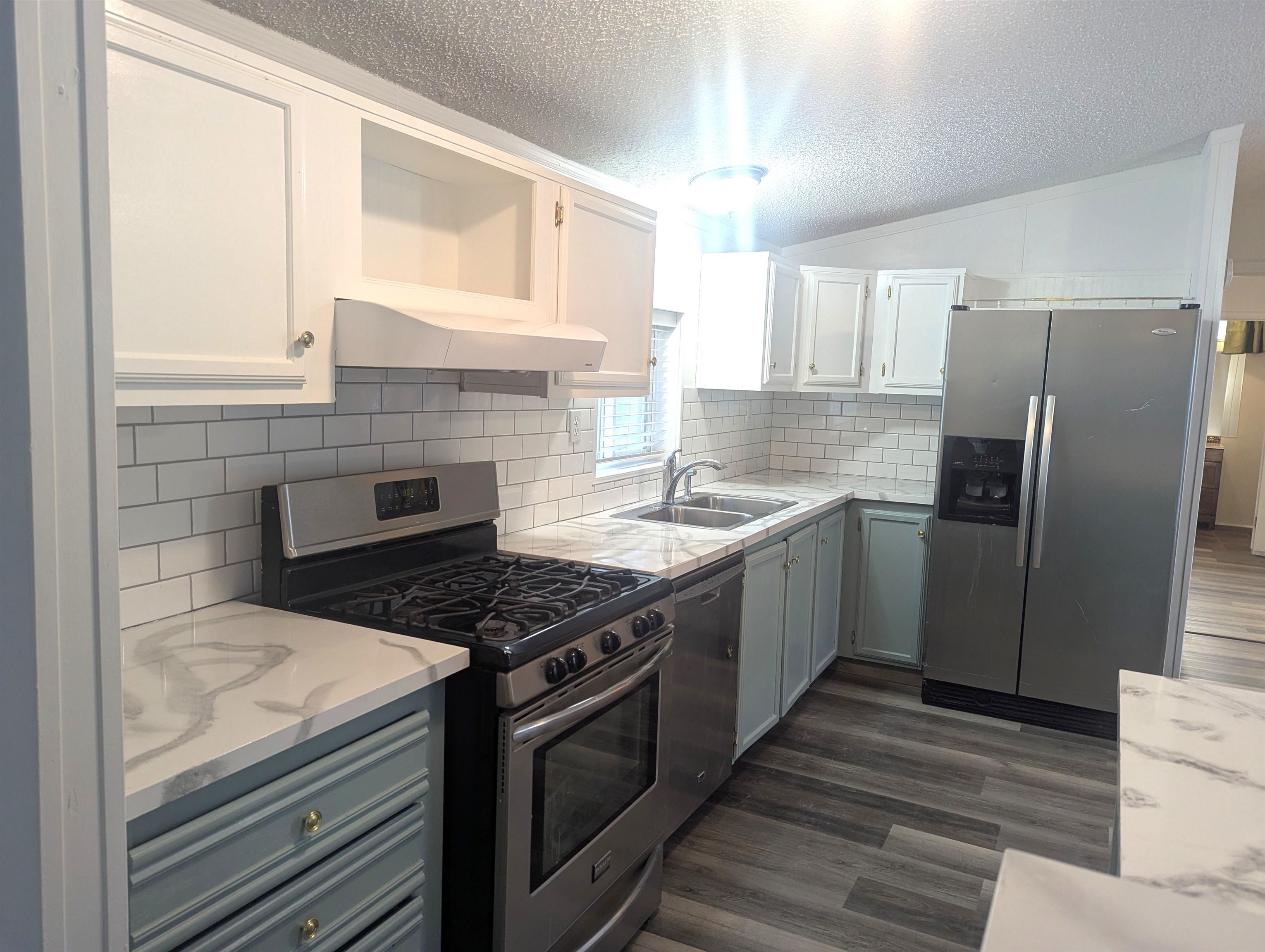 435 32 Road, Unit 254 Clifton, CO 81520 - Photo 5 of 21 a kitchen with stainless steel appliances granite countertop a stove a refrigerator and a sink