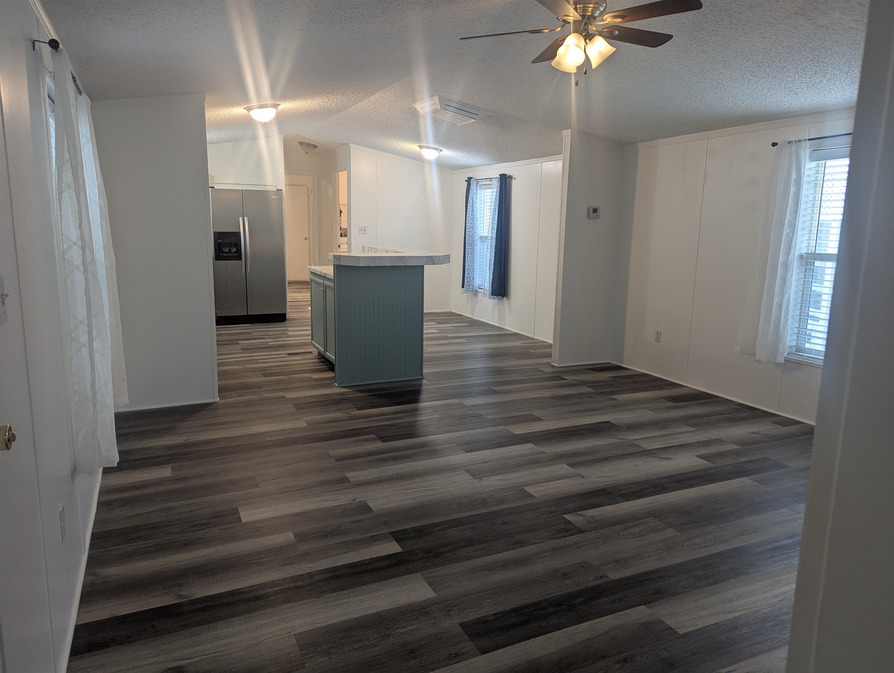435 32 Road, Unit 254 Clifton, CO 81520 - Photo 9 of 21 a view of kitchen and empty room with wooden floor