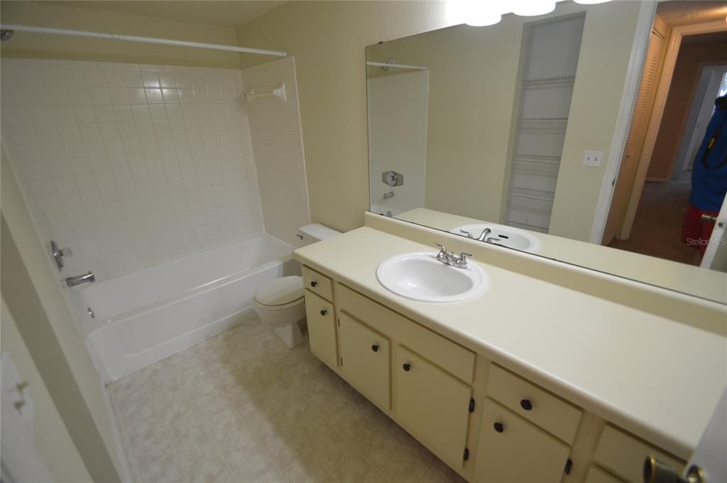4540 Commander Drive, Unit 2225 Orlando, FL 32822 - Photo 8 of 9 a bathroom with a sink a toilet and shower